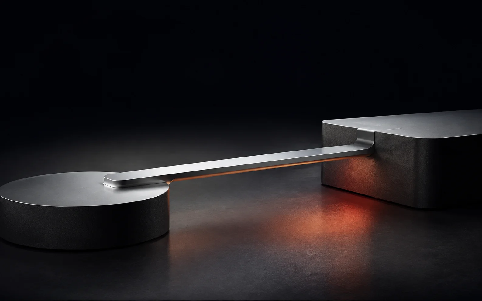A silver bridge linking two platforms in a dark studio